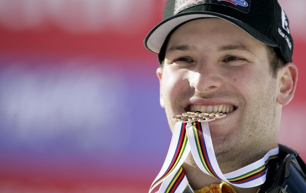 Janyk of Canada bites his bronze medal after the men's Slalom race at the Alpine Skiing World Championships in Val d'Isere